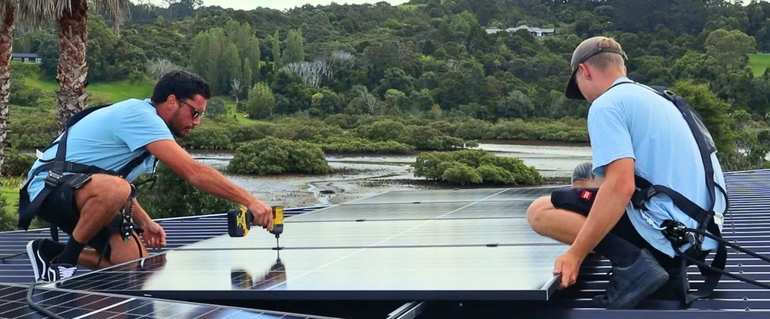 How to choose the right solar installer - A man on a roof installing a solar panel 
