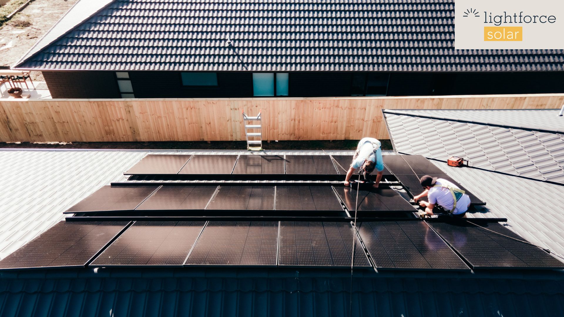 Solar energy vs traditional energy - worker installing solar panel on a house roof